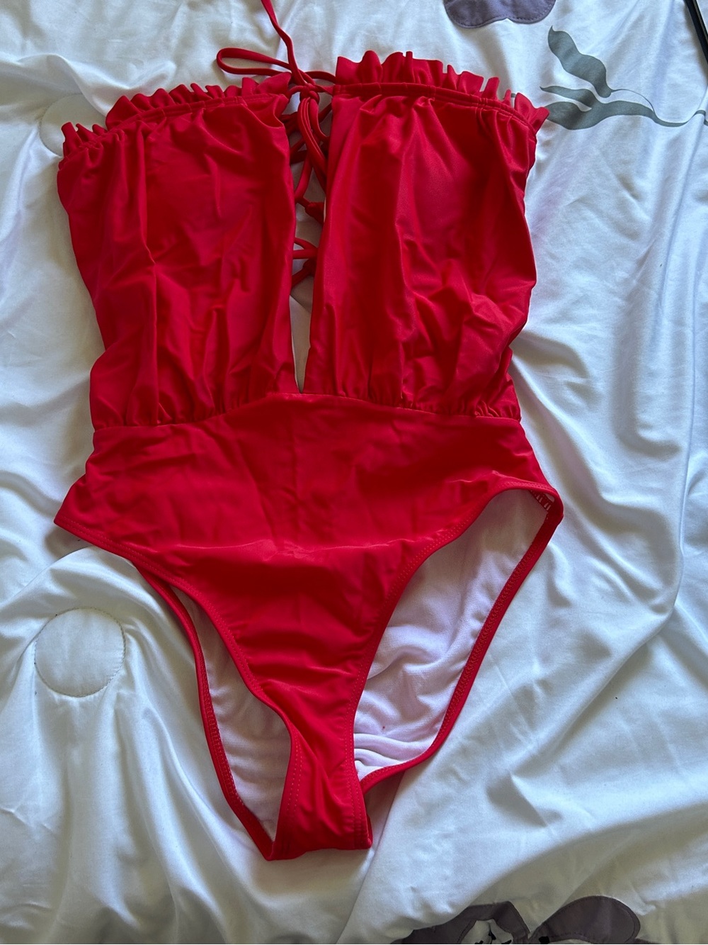Bold red one-piece swimsuit. Strapless style with back lace-up low keyhole front